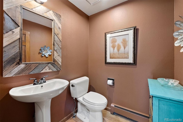 bathroom with toilet and a baseboard radiator