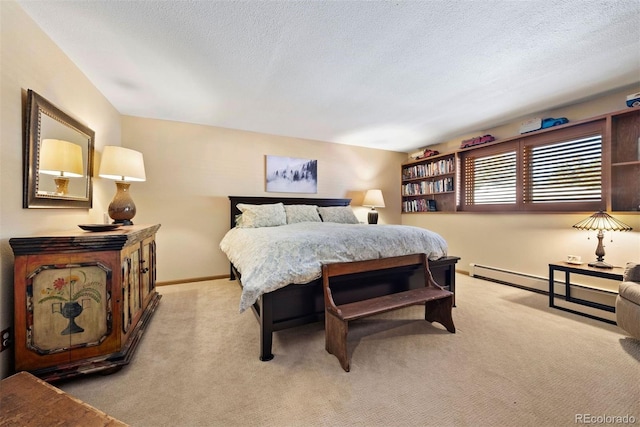 bedroom featuring light carpet and a textured ceiling