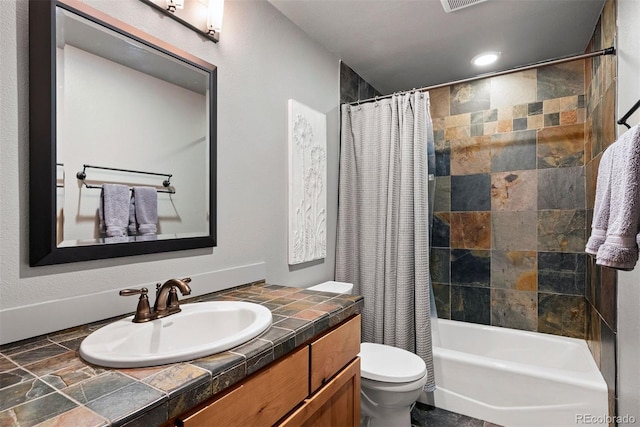 full bathroom featuring vanity, shower / bath combination with curtain, and toilet