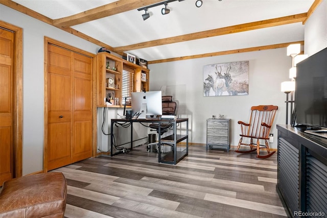 office space with beam ceiling, rail lighting, and dark wood-type flooring