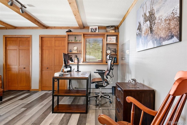 office featuring a textured ceiling, rail lighting, and light hardwood / wood-style flooring