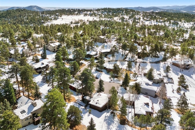 snowy aerial view with a mountain view