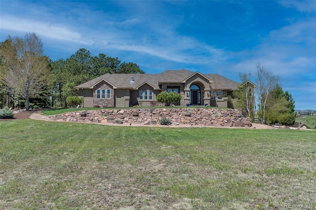 19336 Queens Crescent Way, Monument, CO 80132 - view of front facade with stone siding and a front lawn