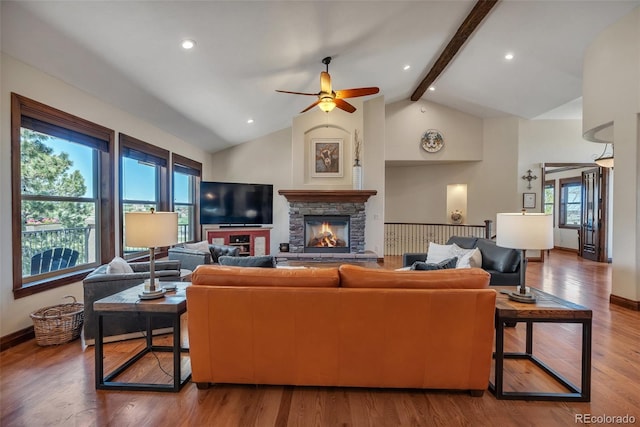 19336 Queens Crescent Way, Monument, CO 80132 - living area featuring a ceiling fan, beam ceiling, a fireplace, wood finished floors, and high vaulted ceiling