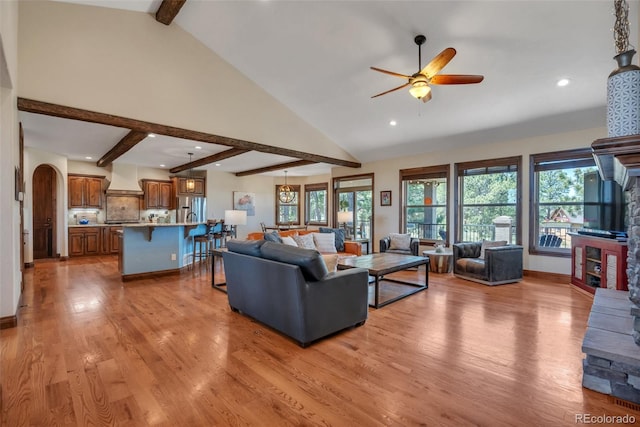 19336 Queens Crescent Way, Monument, CO 80132 - living area with ceiling fan, light wood-style floors, recessed lighting, a fireplace, and arched walkways
