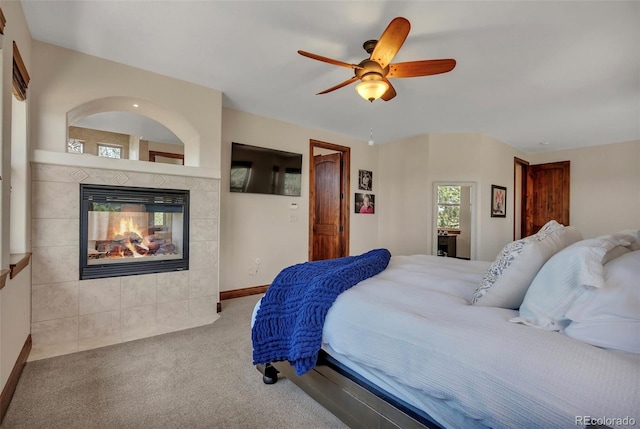 19336 Queens Crescent Way, Monument, CO 80132 - bedroom with carpet flooring, a tiled fireplace, ceiling fan, and baseboards