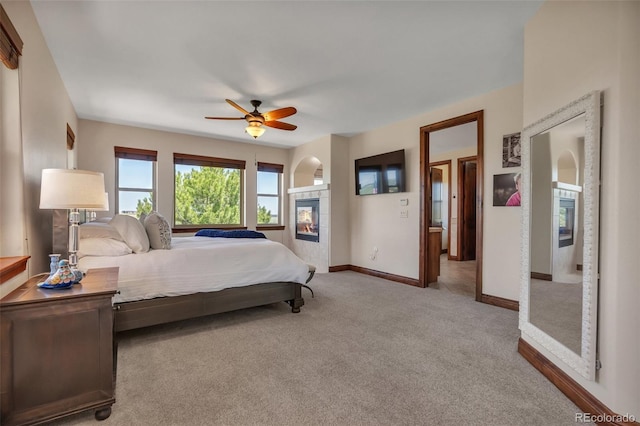 19336 Queens Crescent Way, Monument, CO 80132 - bedroom with baseboards, carpet, ceiling fan, and a fireplace