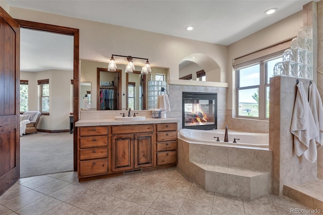 19336 Queens Crescent Way, Monument, CO 80132 - full bathroom with a tiled fireplace, tile patterned flooring, a garden tub, vanity, and recessed lighting