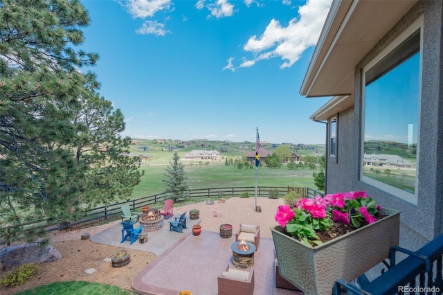 19336 Queens Crescent Way, Monument, CO 80132 - fenced backyard featuring an outdoor fire pit, a patio area, and a view of rural / pastoral area