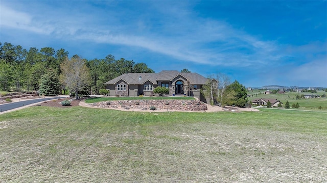 19336 Queens Crescent Way, Monument, CO 80132 - single story home featuring a front lawn and stone siding