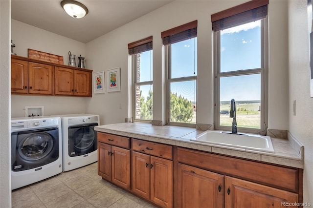 19336 Queens Crescent Way, Monument, CO 80132 - laundry room featuring cabinet space, washer and clothes dryer, and light tile patterned floors