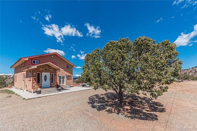 rear view of house featuring a patio