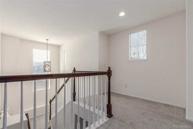 hallway featuring an upstairs landing, carpet flooring, recessed lighting, and baseboards