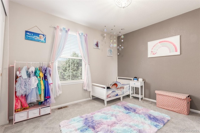 carpeted bedroom featuring baseboards and visible vents