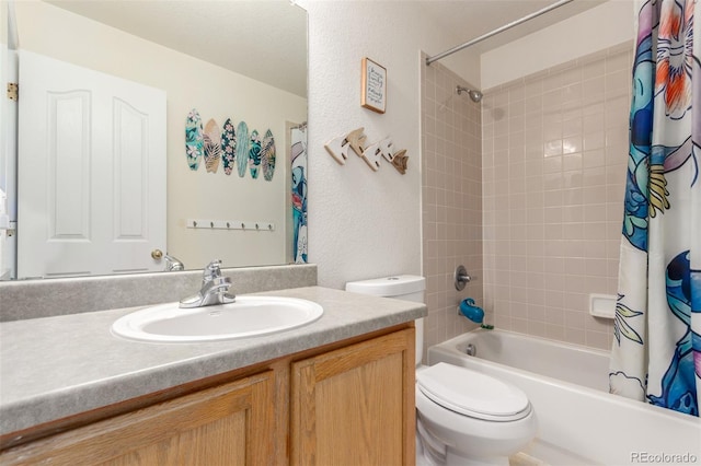 full bath with a textured wall, toilet, vanity, and shower / bath combination with curtain