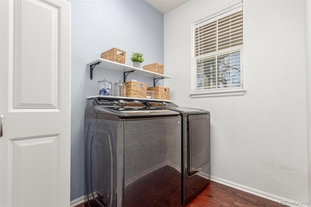 laundry area featuring laundry area, baseboards, dark wood-type flooring, and washer and clothes dryer