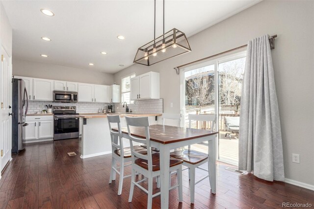 dining room with recessed lighting, visible vents, baseboards, and dark wood-style flooring