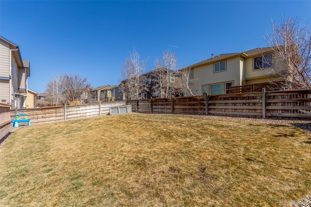 view of yard with a fenced backyard and a residential view