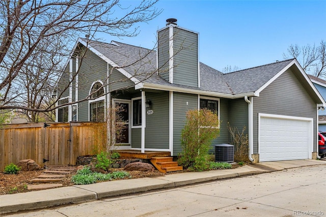 3105 Galileo Ln, Boulder, CO 80301 - view of front facade featuring roof with shingles, an attached garage, cooling unit, a chimney, and concrete driveway