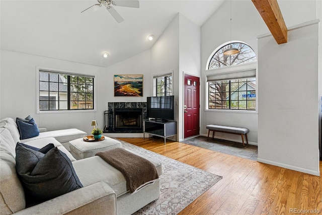 3105 Galileo Ln, Boulder, CO 80301 - living area featuring a fireplace, a ceiling fan, hardwood / wood-style floors, plenty of natural light, and high vaulted ceiling