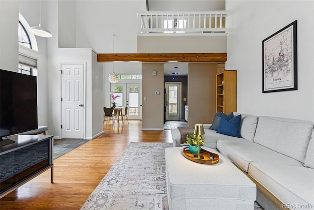 3105 Galileo Ln, Boulder, CO 80301 - living area with a towering ceiling, wood finished floors, baseboards, and french doors