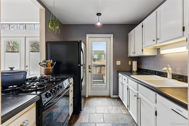3105 Galileo Ln, Boulder, CO 80301 - kitchen featuring black appliances, dark countertops, stone tile flooring, a sink, and white cabinets