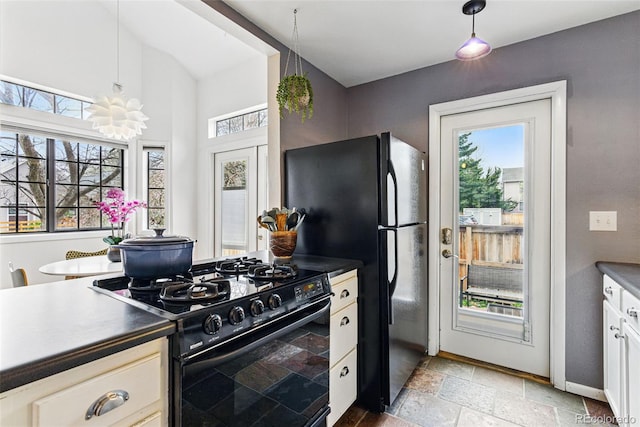 3105 Galileo Ln, Boulder, CO 80301 - kitchen with black appliances, dark countertops, stone tile flooring, and pendant lighting