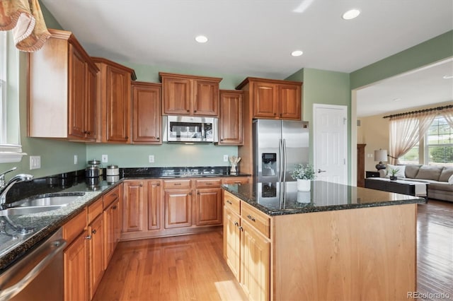 5603 Van Bibber Ct, Golden, CO 80403 - kitchen featuring stainless steel appliances, light wood-style flooring, dark stone countertops, a center island, and recessed lighting