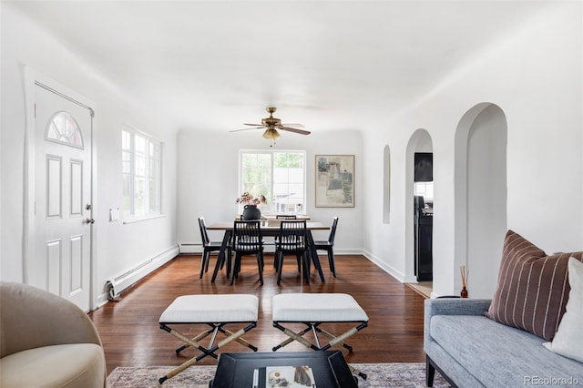 2895 S Sherman St, Englewood, CO 80113 - dining space featuring a baseboard radiator, arched walkways, ceiling fan, and wood finished floors