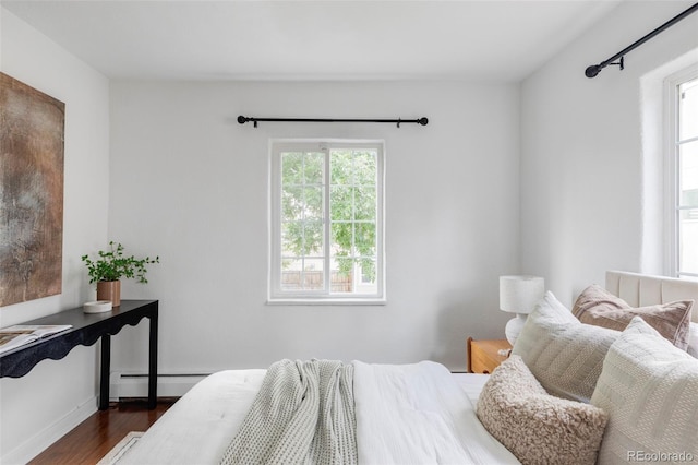 2895 S Sherman St, Englewood, CO 80113 - bedroom featuring a baseboard heating unit and dark wood-style flooring
