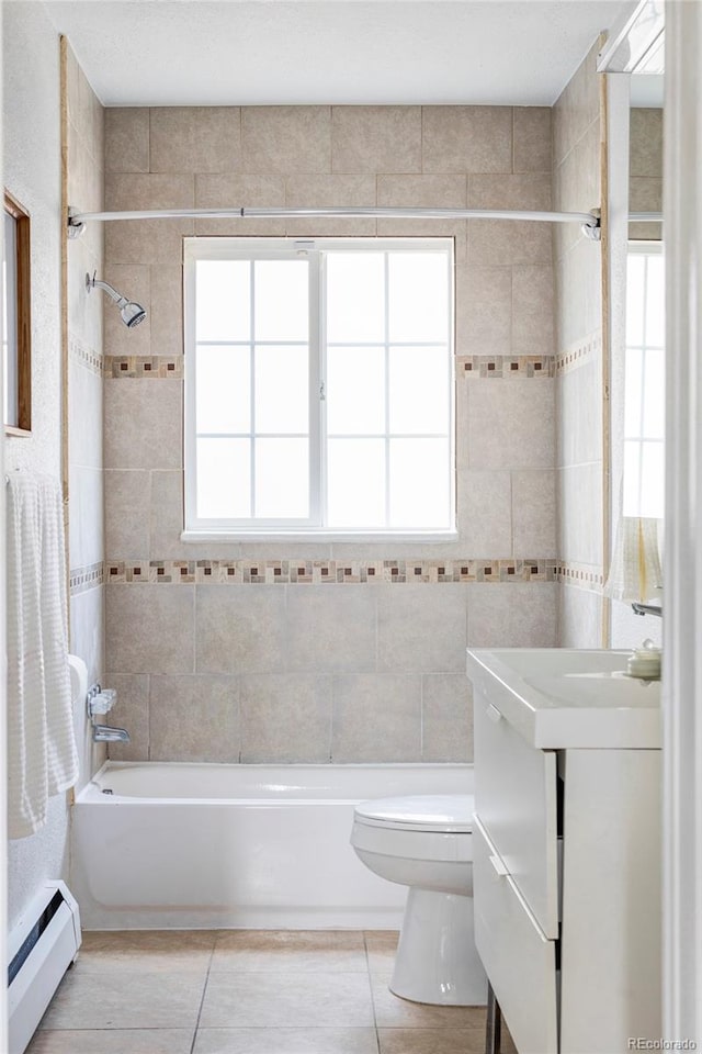 2895 S Sherman St, Englewood, CO 80113 - bathroom with baseboard heating, tub / shower combination, vanity, tile patterned floors, and plenty of natural light