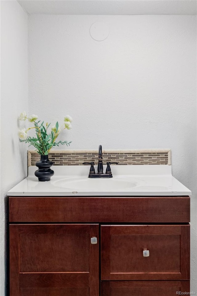2895 S Sherman St, Englewood, CO 80113 - bathroom with vanity and decorative backsplash