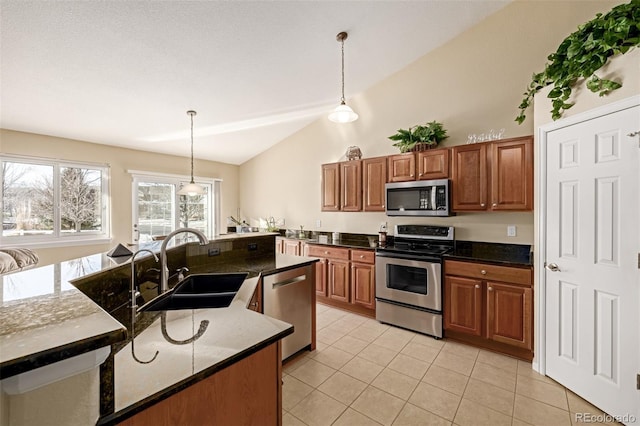 kitchen featuring decorative light fixtures, light tile patterned floors, sink, and stainless steel appliances