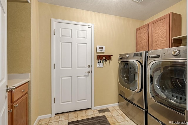 laundry room with washer and dryer and cabinets