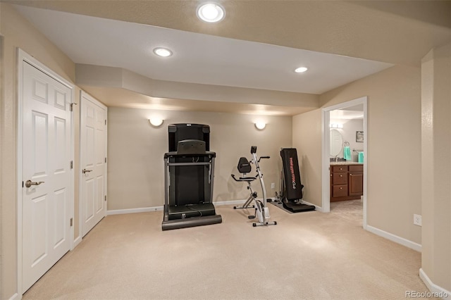 workout area featuring light carpet