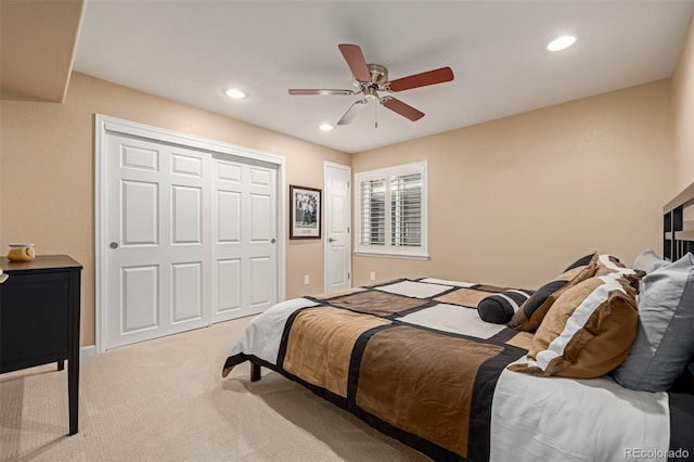 carpeted bedroom with ceiling fan and a closet