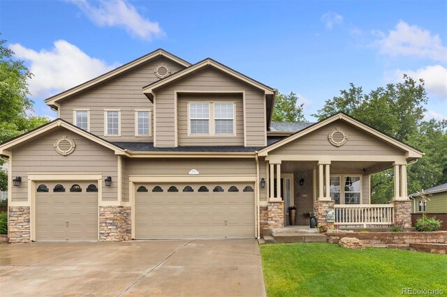 1831 Ashford Cir, Longmont, CO 80504 - view of front facade with covered porch, a garage, stone siding, and driveway