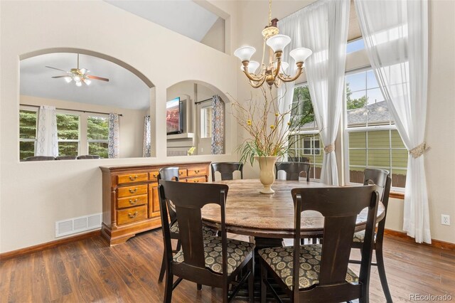 1831 Ashford Cir, Longmont, CO 80504 - dining room with baseboards, a chandelier, dark wood-style flooring, ceiling fan, and high vaulted ceiling