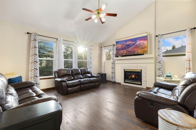 1831 Ashford Cir, Longmont, CO 80504 - living area with ceiling fan, vaulted ceiling, a tile fireplace, dark wood-type flooring, and baseboards