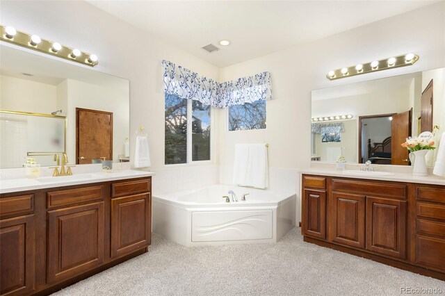 1831 Ashford Cir, Longmont, CO 80504 - ensuite bathroom featuring two vanities, a bath, an enclosed shower, and carpet