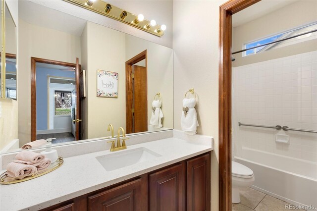 1831 Ashford Cir, Longmont, CO 80504 - bathroom with toilet, vanity, tile patterned flooring, and shower / bath combination