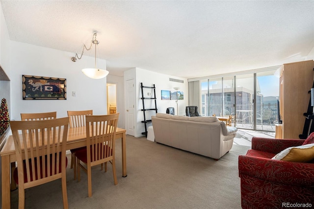 carpeted dining space with floor to ceiling windows