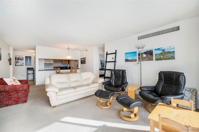 carpeted living room featuring a textured ceiling