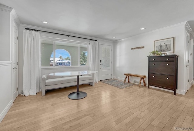 living area featuring light hardwood / wood-style flooring and ornamental molding