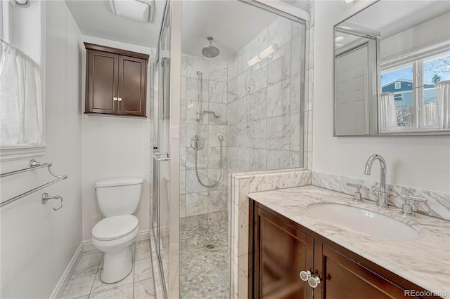 bathroom featuring toilet, an enclosed shower, and vanity