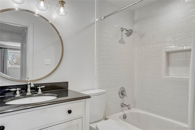 full bathroom featuring toilet, tiled shower / bath combo, and vanity