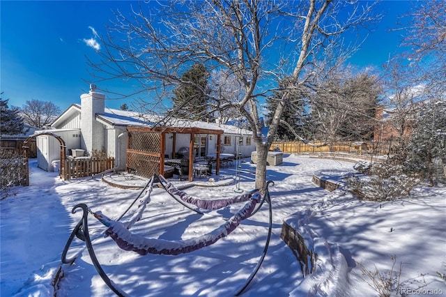 yard layered in snow with a storage shed