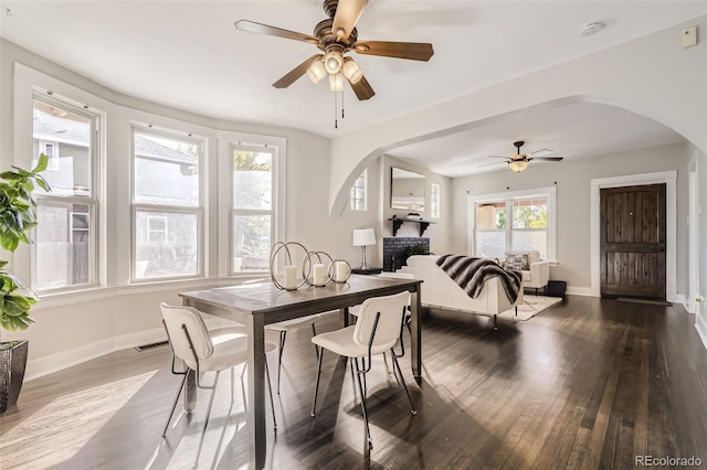 dining space featuring dark wood-type flooring and ceiling fan