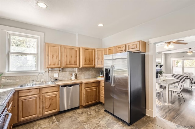 kitchen featuring ceiling fan, a healthy amount of sunlight, appliances with stainless steel finishes, and sink