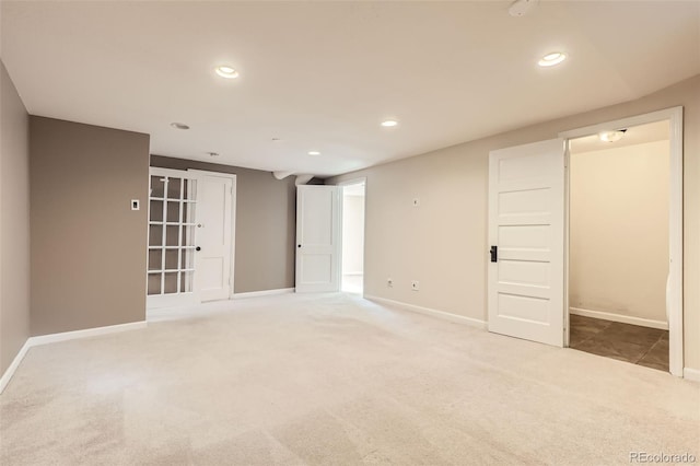 unfurnished room featuring light carpet